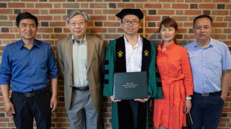 Celebrating commencement with Dr. Qubin Qin (holding diploma) are (from L) his father Zhaohui Qin, his Ph.D. advisor Dr. Jian Shen, his mother Xiaohong Ni, and his uncle Weidong Ni. Qin's family traveled to the ceremony from Anhui province, China. © N. Meyer/W&M.