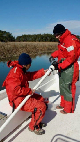 Semedo and fellow Ph.D. student Kenneth Czalpa collect a sediment sample from a tidal creek on Virginia's Eastern Shore. Semedo designed his study to sample during all seasons, including the chill of winter. © S. Fate/VIMS ESL.