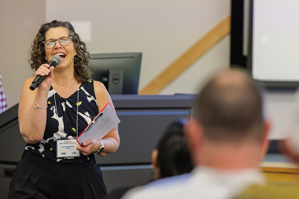 Lisa Lawrence, VIMS MAP marine education program leader, welcomes attendees to the 32nd annual Chefs' Seafood Symposium. Photo credit: Lathan Goumas | Virginia Sea Grant