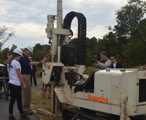 Laboratory Manager Jenn Connell shows Virginia Governor, Terry McAuliffe, how to collect sediment cores with Geoprobe drill rig