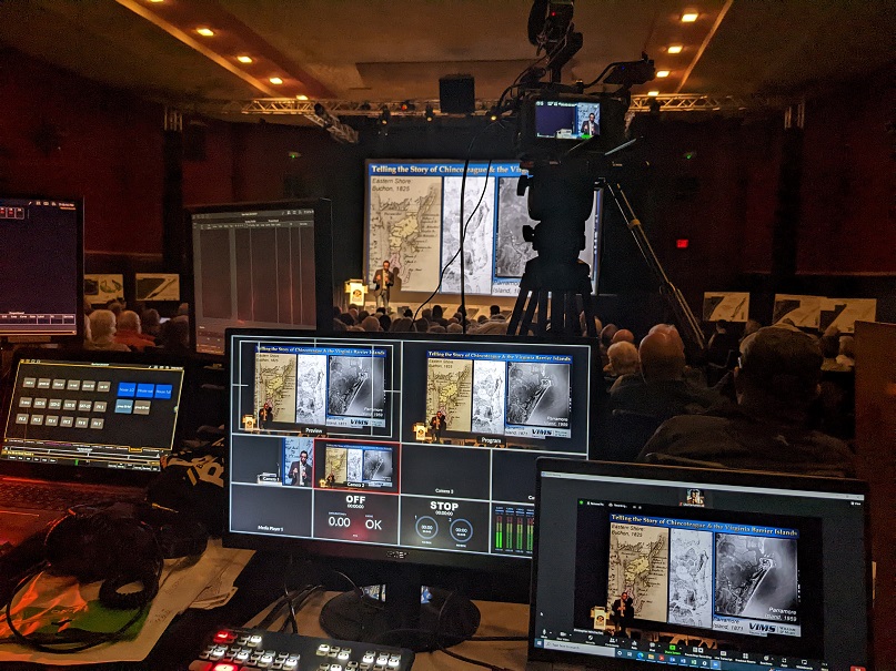 Photo from the camera control room inside the Chincoteague Theater, while Chris Hein gives presentation on the stage
